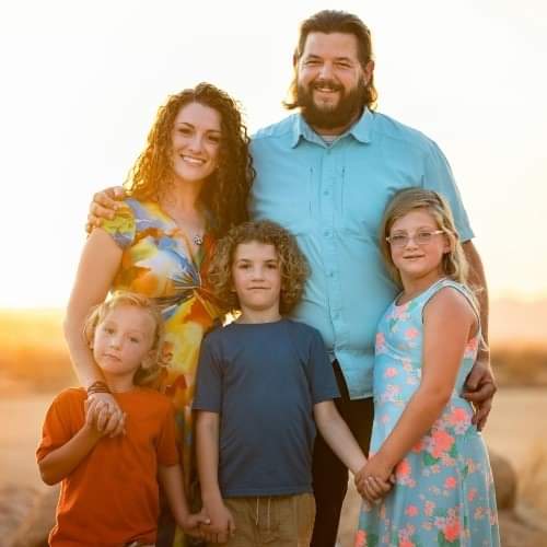 Prisma worldschooling family of five posing together at golden hour sunset
