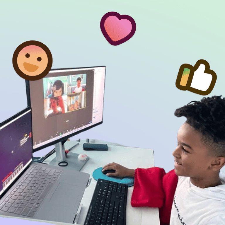 young student smiling at computer during Prisma online video class with emoji reactions