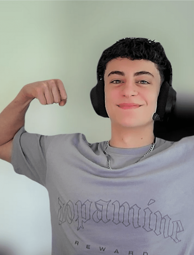 smiling Prisma teen wearing headphones flexing his arm confidently