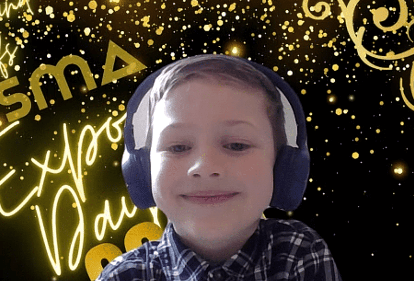 young Prisma student wearing headphones smiling at Expo Day virtual celebration