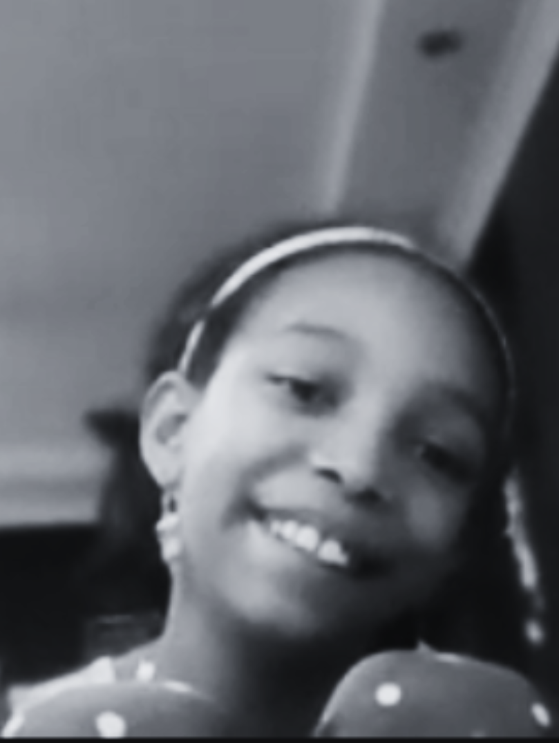 smiling Prisma middle school student on a video call in black and white