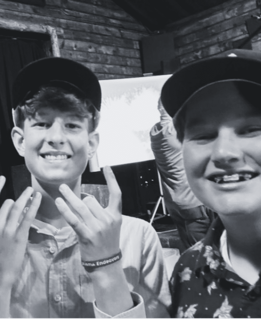two Prisma middle school boys smiling and posing for a selfie in black and white