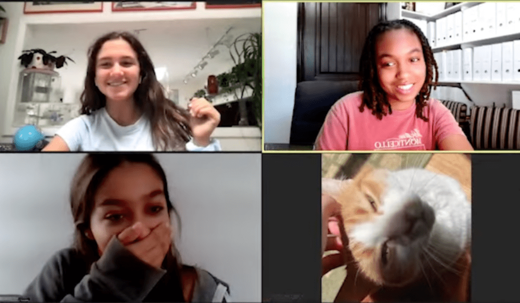Prisma middle school students smiling on a group video call with a pet bunny