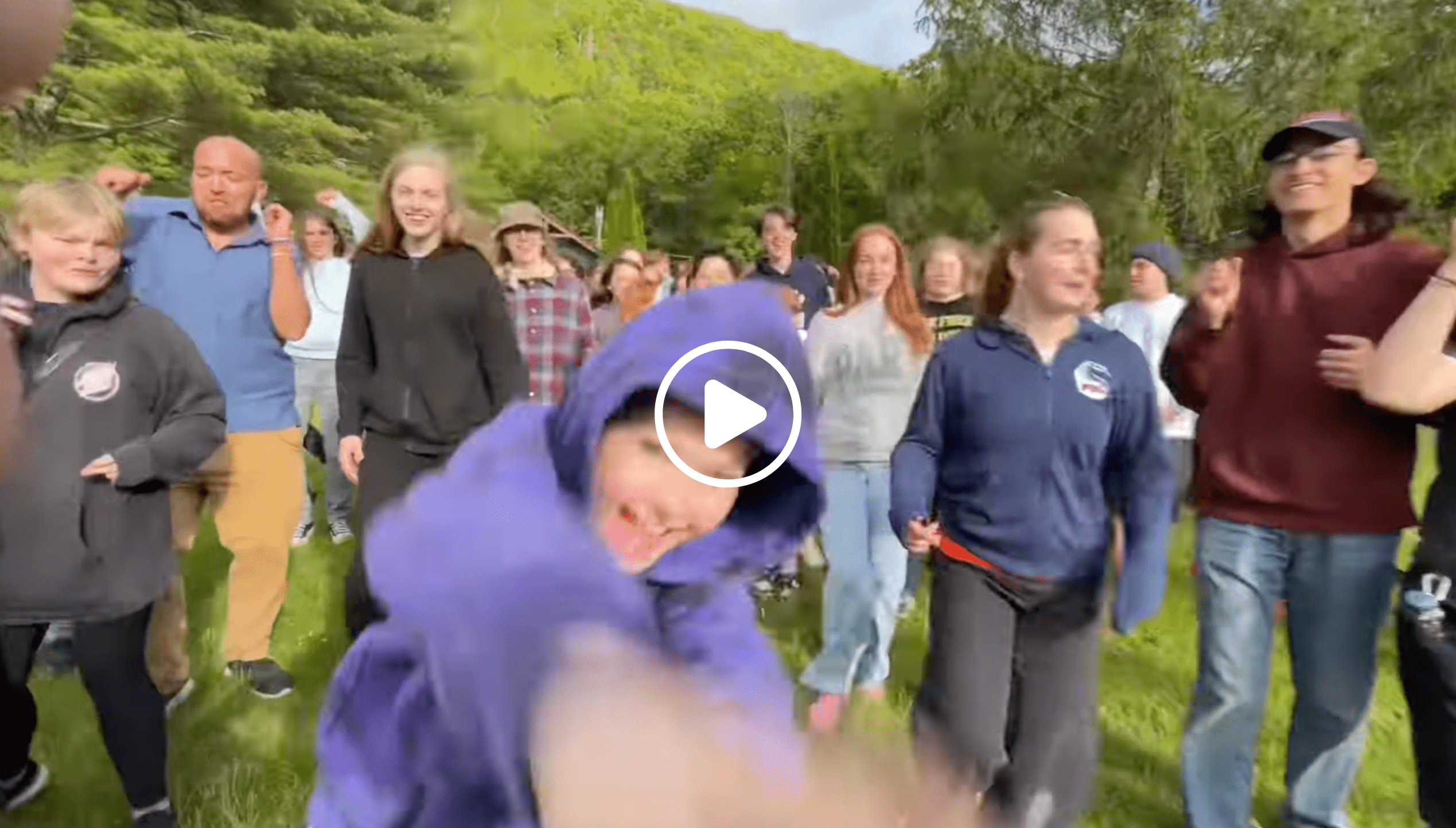 video thumbnail of Prisma learners and coaches dancing together outdoors at a community meetup
