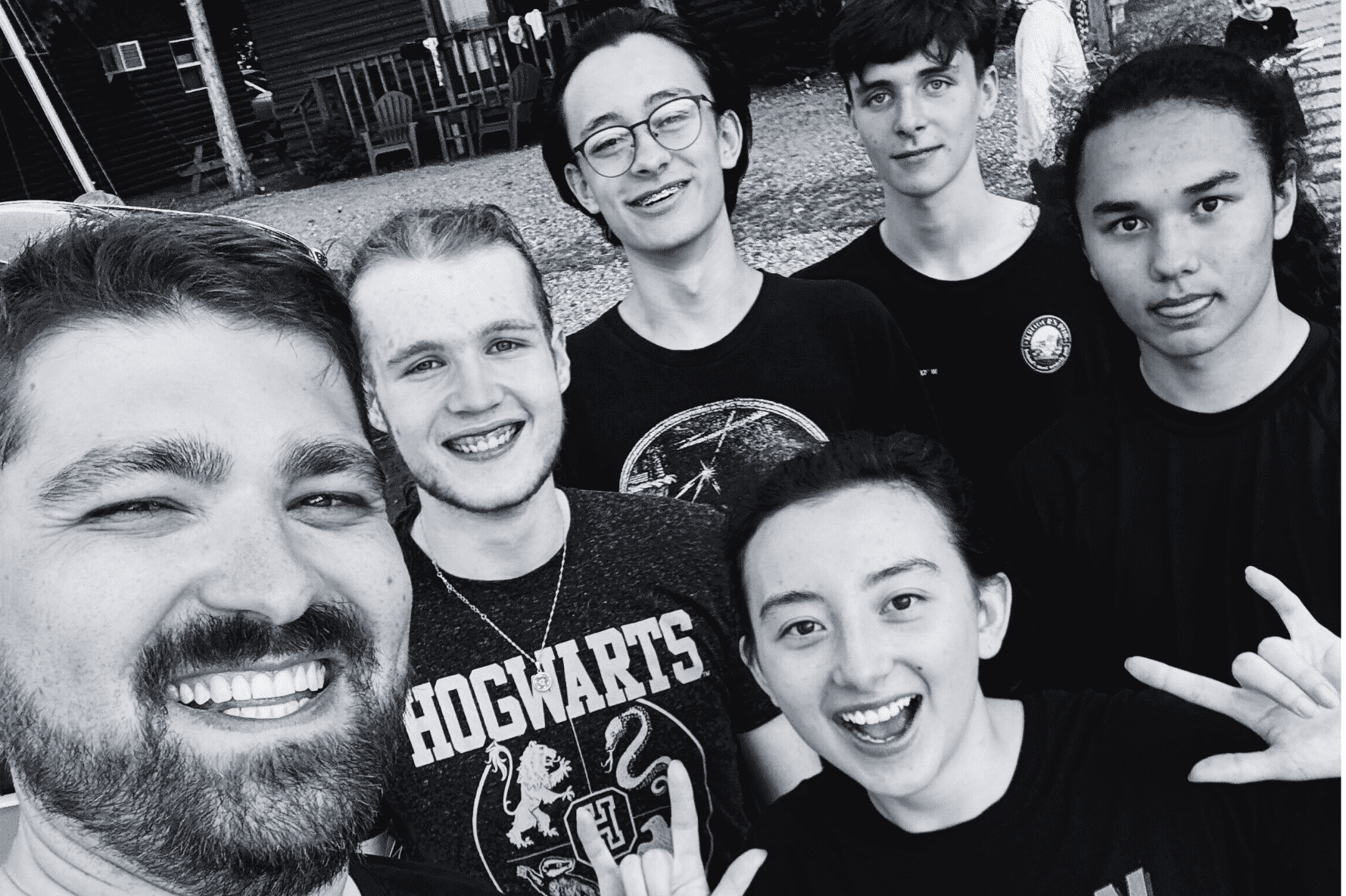Prisma coach and five high school students smiling together in a group selfie
