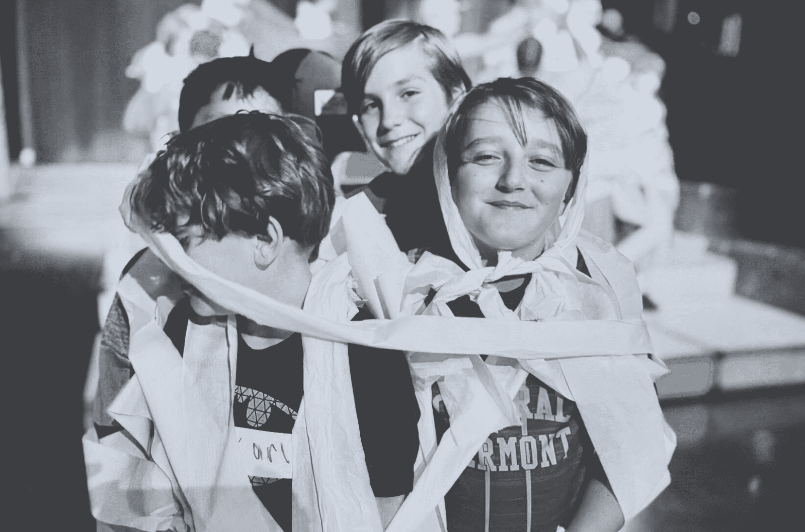 Prisma middle school learners smiling and wrapped in streamers at a fun school event