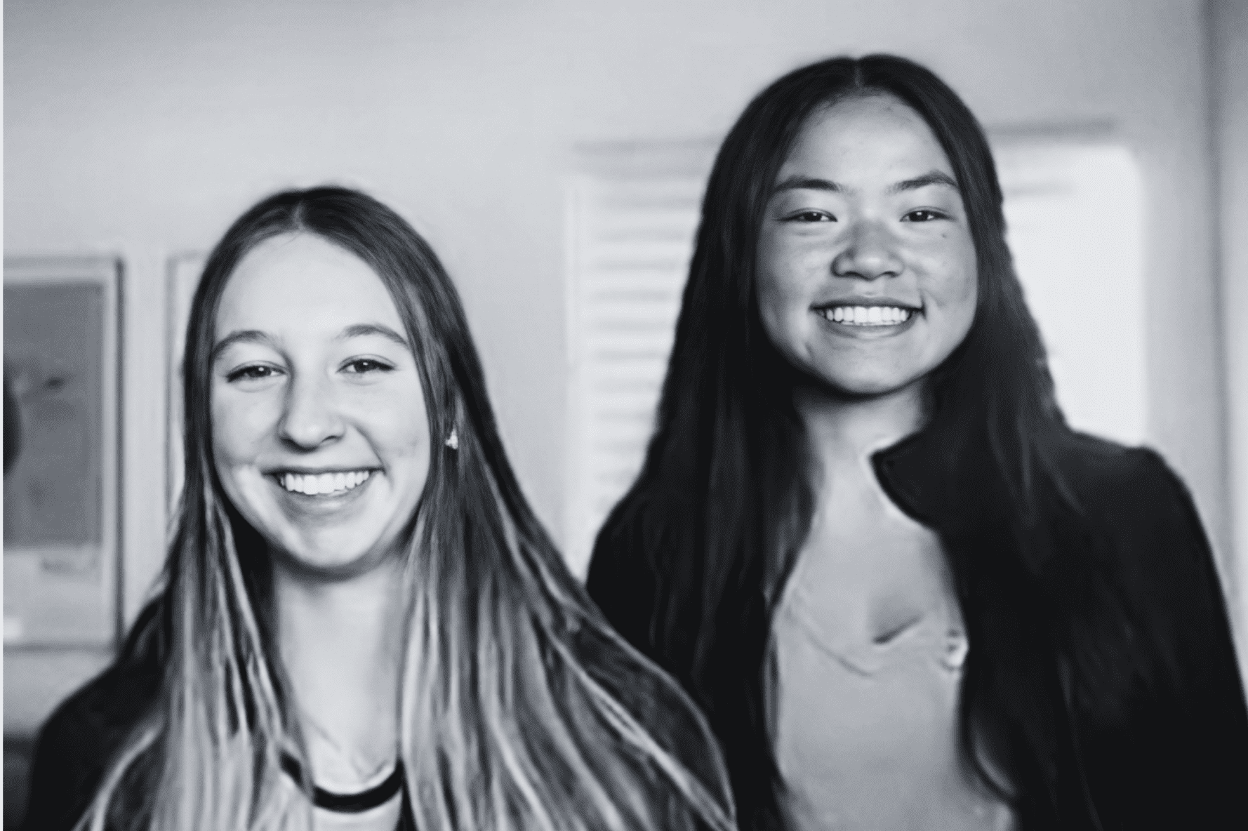 two smiling Prisma high school students in a black and white portrait