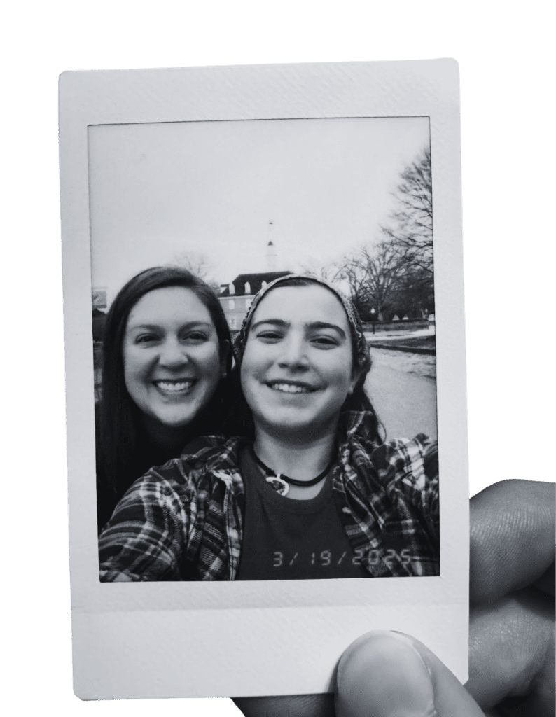 two Prisma high school friends smiling together in a polaroid selfie