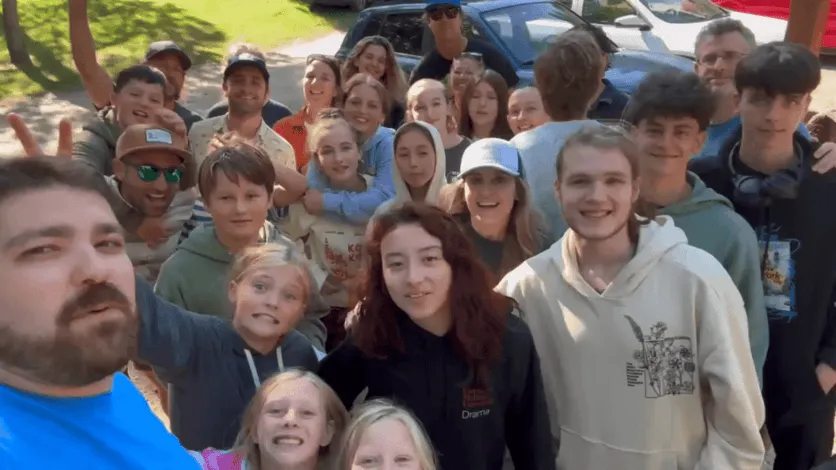 large group selfie of Prisma learners and coaches at an in-person meetup