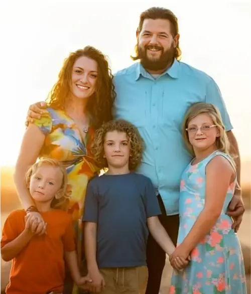 Prisma family of five smiling together during a golden hour outdoor portrait