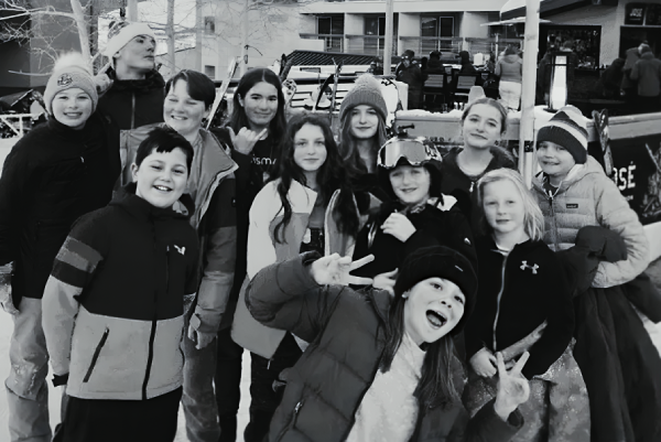 group of Prisma kids smiling together in winter gear at a ski retreat homeschool meetup